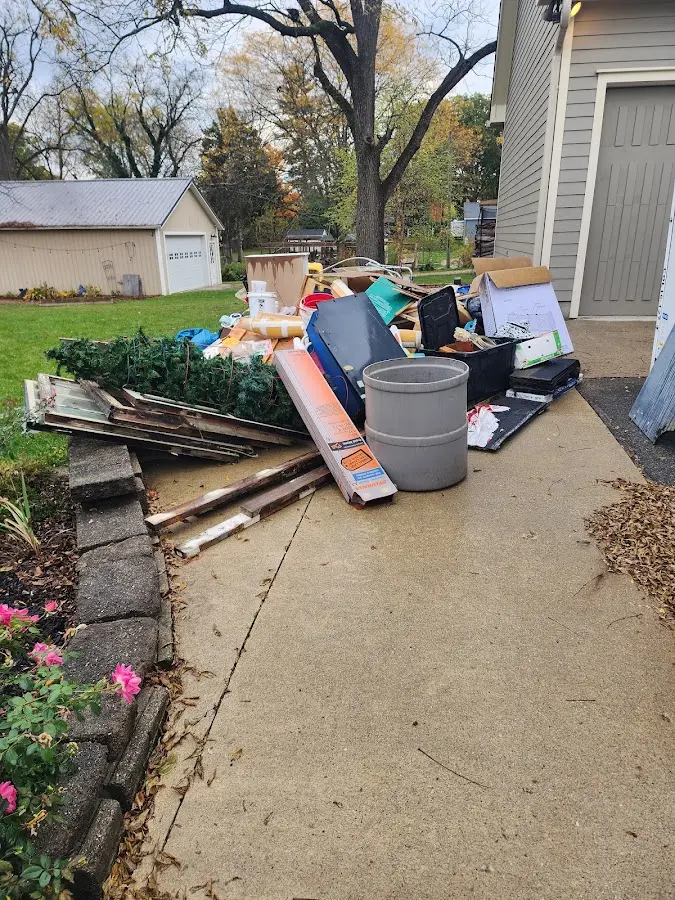 Dumpster being loaded with debris for Estate Cleanout Dumpster Rental in Orem